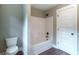 Clean bathroom with a combination tub and shower with a white shower curtain at 939 Jean Ct, Covington, GA 30014