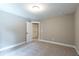 A carpeted bedroom with neutral walls and white trim provides a simple yet comfortable living space at 939 Jean Ct, Covington, GA 30014