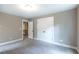 Bedroom featuring neutral carpet, trim, and closet at 939 Jean Ct, Covington, GA 30014