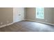 Bedroom featuring neutral carpet, trim, and double door closet at 939 Jean Ct, Covington, GA 30014