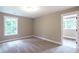 Bright bedroom featuring neutral carpet, base trim, and windows at 939 Jean Ct, Covington, GA 30014