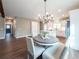 Dining room with view of kitchen, featuring modern chandelier and a view of the hallway at 939 Jean Ct, Covington, GA 30014