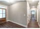 Hallway with wood-look floors leads to the front door and bedrooms with white doors and trim at 939 Jean Ct, Covington, GA 30014