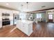 Open kitchen with white cabinets, stainless steel appliances, and a seamless transition to the living area at 939 Jean Ct, Covington, GA 30014