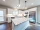 Modern kitchen featuring white cabinets, stainless steel appliances, and a kitchen island at 939 Jean Ct, Covington, GA 30014