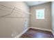 The laundry room has wood-look floors, neutral paint, and a window for natural light at 939 Jean Ct, Covington, GA 30014
