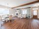 Spacious living and dining area with a brick fireplace and beautiful wood beam accents at 939 Jean Ct, Covington, GA 30014