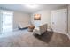 Carpeted living room area featuring a round wicker table between two couches at 939 Jean Ct, Covington, GA 30014