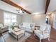 Open-concept living area showcasing wood beams and stylish furnishings at 939 Jean Ct, Covington, GA 30014