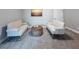 Cozy living room with neutral carpet, tufted couches, and round wicker table at 939 Jean Ct, Covington, GA 30014