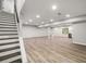 Finished basement with stairs, recessed lighting, and durable flooring at 1590 Highland Farm Dr, Suwanee, GA 30024