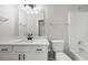 Bathroom with tub, toilet and vanity with black hardware at 1590 Highland Farm Dr, Suwanee, GA 30024
