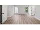 Spacious bedroom features hardwood floors and two windows for natural light at 1590 Highland Farm Dr, Suwanee, GA 30024