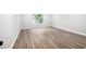 Bedroom with wood flooring, white trim, and natural light from a window at 1590 Highland Farm Dr, Suwanee, GA 30024