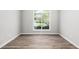 Bedroom features natural light and luxury vinyl plank flooring at 1590 Highland Farm Dr, Suwanee, GA 30024