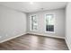 Bedroom with two windows offering natural light and luxury vinyl plank flooring at 1590 Highland Farm Dr, Suwanee, GA 30024