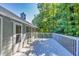 Enjoy wooded views from the spacious gray exterior deck at 1590 Highland Farm Dr, Suwanee, GA 30024