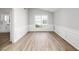 Dining room with chair railing, modern laminate floors and a large window at 1590 Highland Farm Dr, Suwanee, GA 30024