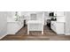 Modern kitchen with white cabinetry, island, stainless steel appliances, and laminate floors at 1590 Highland Farm Dr, Suwanee, GA 30024