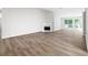 Bright and spacious living room with hardwood flooring, a fireplace, and large windows at 1590 Highland Farm Dr, Suwanee, GA 30024