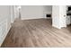 Open layout with modern laminate floors, chair railing, and neutral paint throughout at 1590 Highland Farm Dr, Suwanee, GA 30024