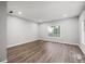 Bright living room with wood flooring and large windows at 1590 Highland Farm Dr, Suwanee, GA 30024