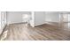 Open floor plan of living room and kitchen with luxury vinyl plank flooring throughout at 1590 Highland Farm Dr, Suwanee, GA 30024