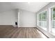 Bright living room featuring a fireplace, large windows and luxury vinyl plank flooring at 1590 Highland Farm Dr, Suwanee, GA 30024