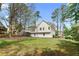 Spacious backyard featuring a deck and ample greenery at 3407 Deerwood Ct, Rex, GA 30273
