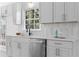 Stylish kitchen featuring white cabinets, quartz countertops, and stainless appliances at 3407 Deerwood Ct, Rex, GA 30273