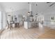 Open layout with island and seating with view into kitchen and dining spaces at 3407 Deerwood Ct, Rex, GA 30273