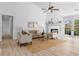 Spacious living room with a fireplace, ceiling fan, neutral furniture, and lots of natural light at 3407 Deerwood Ct, Rex, GA 30273