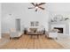 Open-concept living room features a vaulted ceiling, fireplace, ceiling fan and light, neutral furniture at 3407 Deerwood Ct, Rex, GA 30273