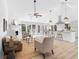 Open-concept living area showcasing a fireplace, bright kitchen, and dining space at 3407 Deerwood Ct, Rex, GA 30273