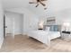 Bright main bedroom features a ceiling fan, two windows, neutral furniture, and hardwood floors at 3407 Deerwood Ct, Rex, GA 30273