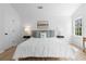 Bright main bedroom features a ceiling fan, two windows, neutral furniture, and hardwood floors at 3407 Deerwood Ct, Rex, GA 30273