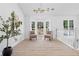 Bright sitting area with neutral chairs, large windows, and hardwood floors at 3407 Deerwood Ct, Rex, GA 30273