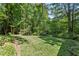 Spacious backyard features mature trees and greenery creating a private outdoor oasis at 4590 Lake Forrest Nw Dr, Atlanta, GA 30342