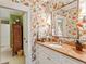 Stylish bathroom with colorful wallpaper, vanity with bowl sink and large mirror at 4590 Lake Forrest Nw Dr, Atlanta, GA 30342