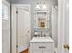 Charming bathroom with a decorative mirror, marble countertop and white cabinetry at 4590 Lake Forrest Nw Dr, Atlanta, GA 30342