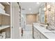 Elegant bathroom with marble countertops, decorative wallpaper, and a walk-in shower, providing a spa-like experience at 4590 Lake Forrest Nw Dr, Atlanta, GA 30342