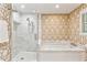 Bright bathroom featuring a glass shower, a bathtub, marble tiling and decorative wallpaper at 4590 Lake Forrest Nw Dr, Atlanta, GA 30342