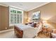 Comfortable bedroom featuring a large window and earth-tone walls, creating a calming atmosphere at 4590 Lake Forrest Nw Dr, Atlanta, GA 30342