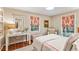 Inviting bedroom with a desk, chair, bedside table and colorful window treatments at 4590 Lake Forrest Nw Dr, Atlanta, GA 30342