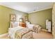 Bedroom with twin beds and olive green walls creating a cozy and inviting space at 4590 Lake Forrest Nw Dr, Atlanta, GA 30342