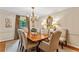 Formal dining room featuring a classic chandelier, elegant furniture, and serene window views at 4590 Lake Forrest Nw Dr, Atlanta, GA 30342