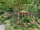 Charming brick home featuring mature trees and lush landscaping create a serene and private setting at 4590 Lake Forrest Nw Dr, Atlanta, GA 30342