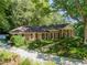Charming brick home with well-manicured lawn, lush landscaping, and inviting curb appeal at 4590 Lake Forrest Nw Dr, Atlanta, GA 30342