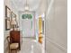 Bright foyer features a vintage dresser, chair, and arched window above the front door at 4590 Lake Forrest Nw Dr, Atlanta, GA 30342
