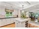 Bright eat-in kitchen boasts white cabinetry, granite countertops, and a stylish island with wine rack for the discerning homeowner at 4590 Lake Forrest Nw Dr, Atlanta, GA 30342